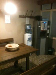 a kitchen with a wooden table and a refrigerator at Agriturismo Dosso al Porto in Rolo