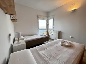 a bedroom with two beds and a window at Myflats Villa Sea Cove in El Campello +19 photos