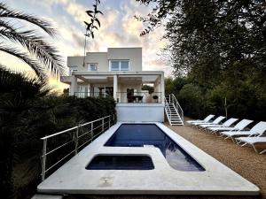 a house with a swimming pool in front of it at Myflats Villa Sea Cove in El Campello