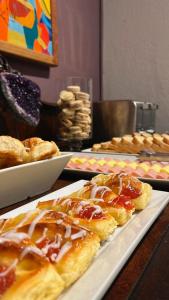 a table with a plate of pastries on a table at VIOLETA HOTEL Boutique in Artigas +15 photos
