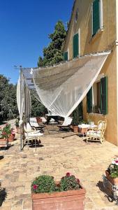 a patio with chairs and plants and a building at B&B Santa Caterina in Acquaviva Picena