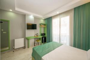 a bedroom with a bed and a green curtain at Green Garden Hotel in Istanbul