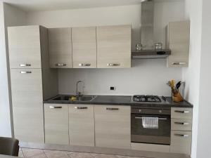 a kitchen with wooden cabinets and a sink at CASA BETTO in San Domenico