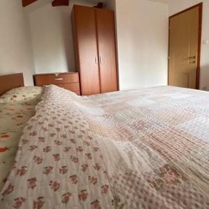 a bedroom with a bed with a quilt on it at Vikendica Drina Hill Loznica in Loznica