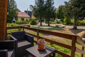 a patio with two chairs and a table with flowers on it at Finnhütten in Freest in Freest