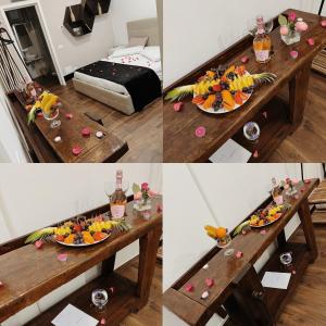 una mesa con frutas y botellas de vino. en Casa Del Profumo, en Piacenza