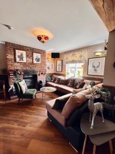 a living room with a couch and a fireplace at The Reindeer Inn in Sandtoft