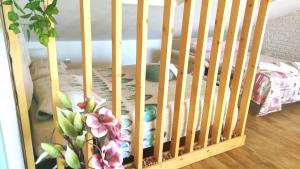 a wooden crib with a crib at Chic & Beauty in Agrigento