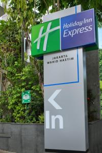 a sign for a hyundai exit sign at Holiday Inn Express Jakarta Wahid Hasyim, an IHG Hotel in Jakarta