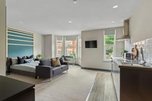 a large living room with a couch and a kitchen at BKT Aparthotel Coventry in Coventry