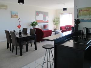 a living room with a table and a couch at Bonza View in Kalorama