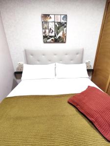 A bed or beds in a room at La Dorada