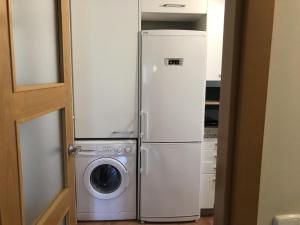 a refrigerator and a washing machine in a room at La Cala Azul 2 bedroom apartment with big sunny terrace & walking distance to all the amenities - costa del sol in La Cala de Mijas