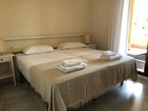 a bedroom with a bed with two towels on it at La Cala Azul 2 bedroom apartment with big sunny terrace & walking distance to all the amenities - costa del sol in La Cala de Mijas +21 photos