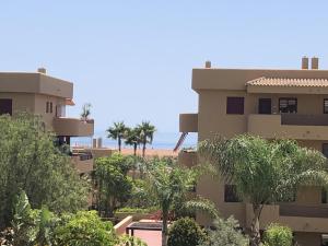 a view of a building with the ocean in the background at La Cala Azul 2 bedroom apartment with big sunny terrace & walking distance to all the amenities - costa del sol in La Cala de Mijas
