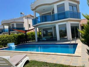 a large house with a swimming pool in front of it at Teker‘s home in Didim