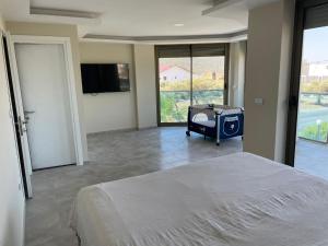 a bedroom with a bed and a flat screen tv at Teker‘s home in Didim