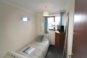 a small room with a bed and a window at Doncaster - Thorne - Great Customer Feedback - 3 Bed Semi Detached House - Private Garden & Parking - Quiet Cul De Sac Location in Doncaster