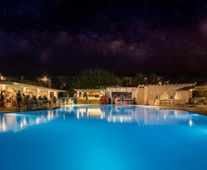 a large swimming pool at night with a starry sky at CHARM BEACH HOTEL in Akyarlar