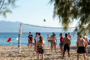 a group of people playing volleyball on the beach at CHARM BEACH HOTEL in Akyarlar