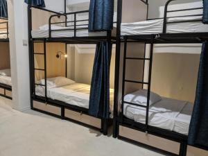 a room with three bunk beds in a room at Ragamuffin Hostel in Kingston