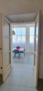 a view of a room with a table and a window at A 2 passi dal mare - grazioso trilocale a Locri in Locri