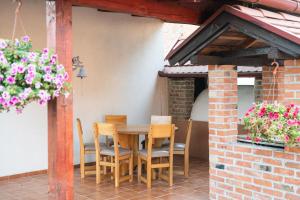 a wooden table and chairs on a patio at Salaš 318 - B&B Farm Experience in Drenovac