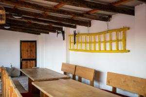 a dining room with wooden tables and chairs at Salaš 318 - B&B Farm Experience in Drenovac
