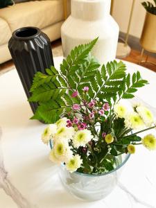 a vase filled with flowers on a table at Luxury Belfast Stay in Belfast