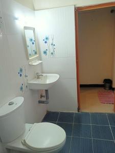 a bathroom with a toilet and a sink at SKY PARK HOTELS in Tiruppūr