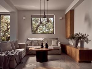 a living room with a couch and a table at Drallos Luxury Villa in Alikanas