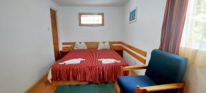 una piccola camera con un tavolo rosso e una sedia blu di Cazare Casa Cristina a Buşteni