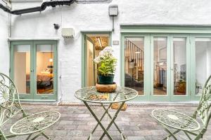 a table with a potted plant on a patio at Guest Homes - The Basement On The Tything in Worcester