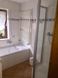 ein Bad mit einer Badewanne, einer Dusche und einem WC in der Unterkunft Stillvoll Wohnen mit Fahrradweg zum Festspielhaus in Heinersreuth