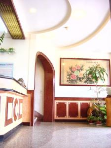 a hallway of a building with a painting on the wall at Jin Lon Hotel in Taitung City