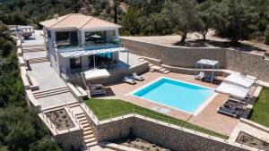 an aerial view of a house with a swimming pool at Aspasia's mansion in Lygia