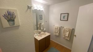 a bathroom with a sink and a mirror and towels at The Summit Inn in Cloudcroft +93 photos