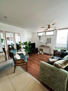 a living room with a couch and a chair at Luxury Belfast Stay in Belfast