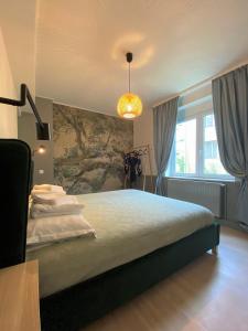 a bedroom with a large bed and a large window at JAY's Park Place in Cluj-Napoca