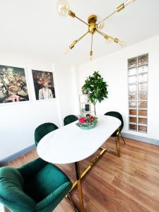 a dining room with a white table and green chairs at Luxury Belfast Stay in Belfast