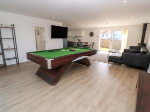 a living room with a pool table in it at Sandy Cove in Penzance