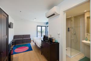 a bedroom with a bed and a shower and a sink at DOMINIUM CITY SUITES in Dubrovnik