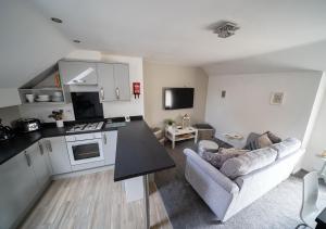 cocina y sala de estar con sofá y mesa en The Cosy Apartment Sherburn in Elmet, en Sherburn in Elmet