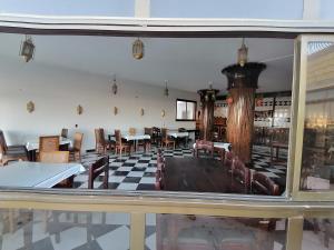 uma sala de jantar com mesas e cadeiras e uma janela em Dahab Bay hotel em Dahab