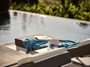 アリカナスにあるDrallos Luxury Villaのスイミングプールの横のテーブルと椅子