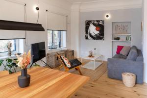 a living room with a couch and a table at Design&Natur - hochwertige Ferienwohnung "Sundowner" in alter Villa in Grünau im Almtal