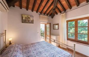 a bedroom with a bed in a room with windows at La Casina Del Melograno in Civitella Marittima