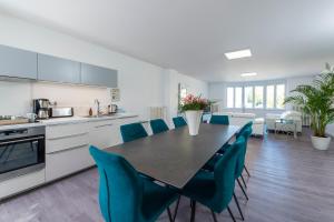 a kitchen and dining room with a table and chairs at Suites Mana - Le Manaloft, Chic et moderne avec salle privée de Fitness en plein centre-ville de Rethel in Rethel