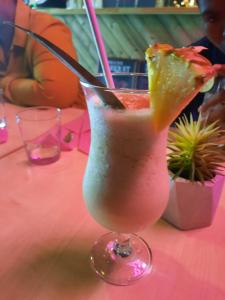 a drink with a slice of fruit in a glass on a table at Locakaz in Sainte-Anne