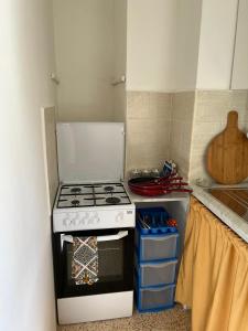 a kitchen with a stove and a refrigerator at Palazzo Porta in Procida